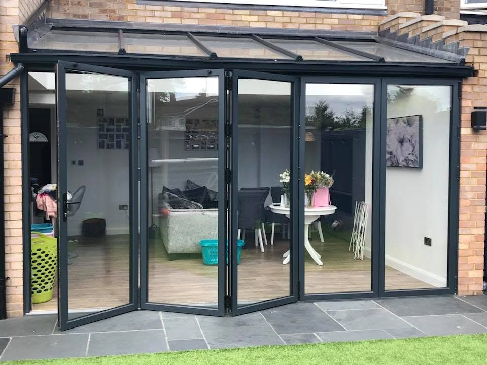 Black aluminium slim bi-folding doors panoramic open