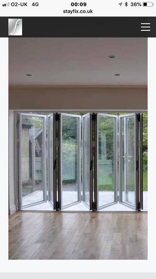 White uPVC bi-folding doors 4 panels open to patio garden
