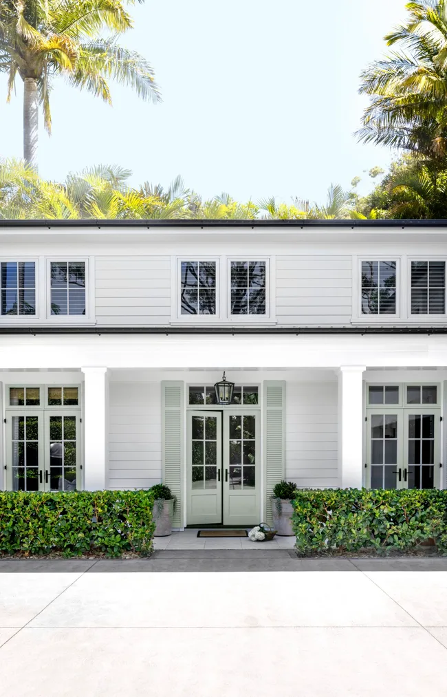 White uPVC French doors open to garden patio exterior