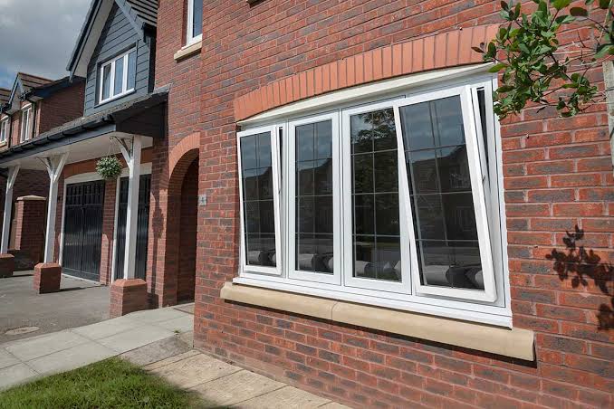 Modern house exterior with black aluminium tilt and turn windows