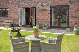 White uPVC French doors double opening to garden patio in brick home