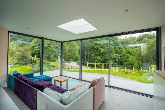 Aluminium sliding patio doors in conservatory overlooking garden